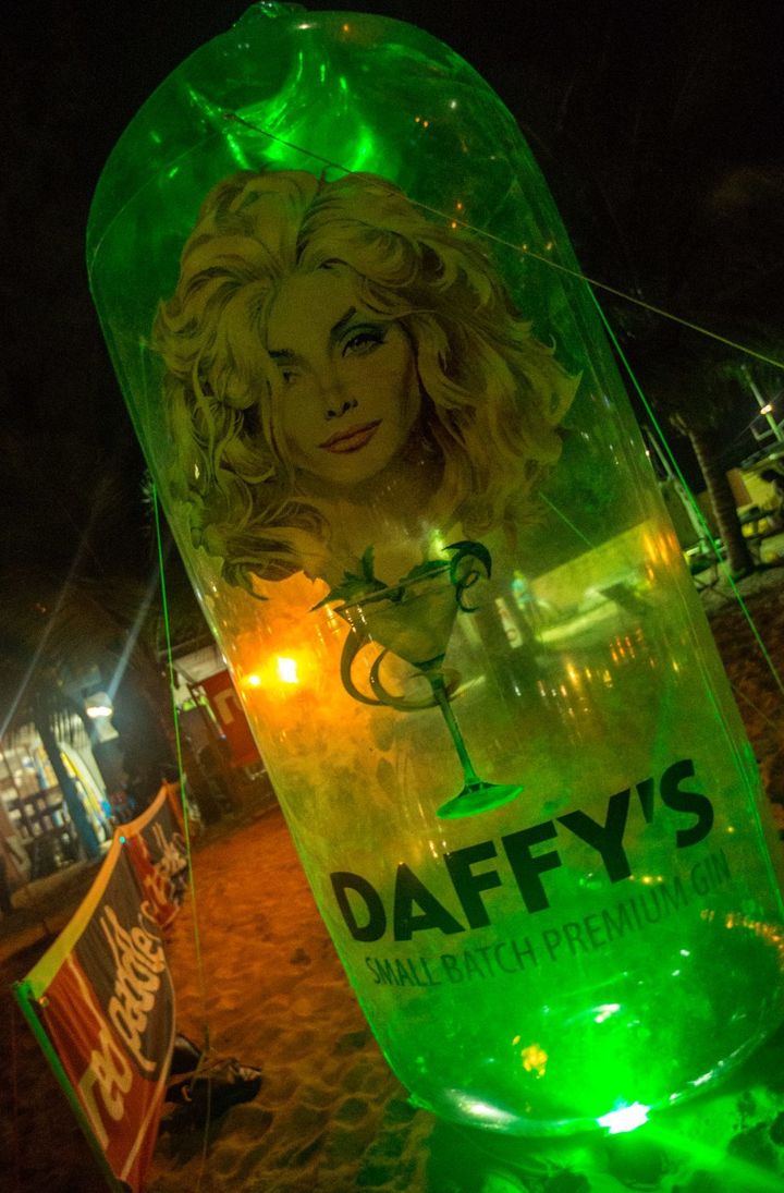 Giant Daffy’s Gin blow up bottle adorning beach race site. 