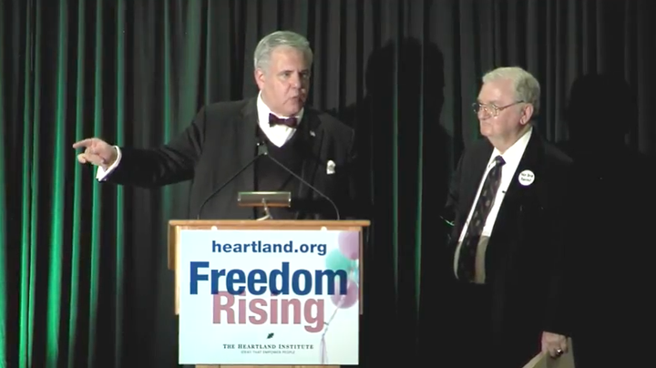 Joseph Morris, left, delivering a speech at the Heartland Institute's 32nd Anniversary Benefit Dinner in September 2016.