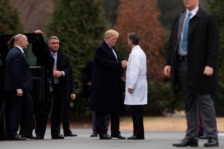 President Donald Trump shakes hands with Rear Adm. Dr. Ronny Jackson following his annual physical at Walter Reed National Military Medical Center in Bethesda, Maryland, Jan. 12, 2018.