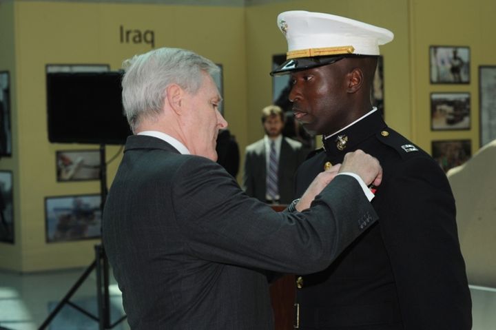  Capt. Ademola Fabayo receiving the Navy Cross. ) 