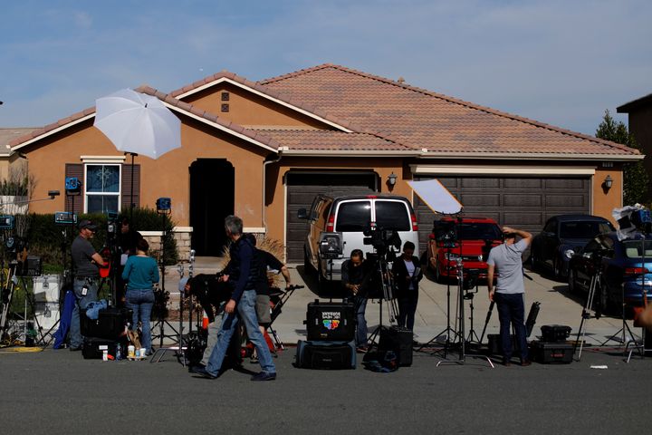 Journalists gather outside the family home after police freed the children on Sunday