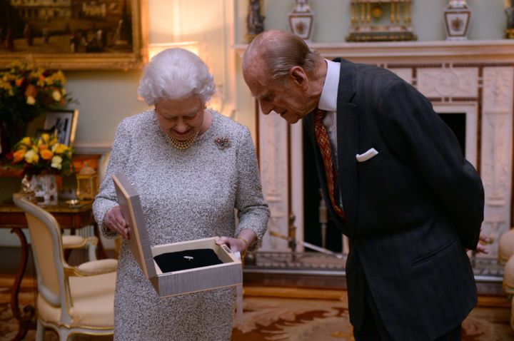 The Queen examines a gift with the Duke of Edinburgh