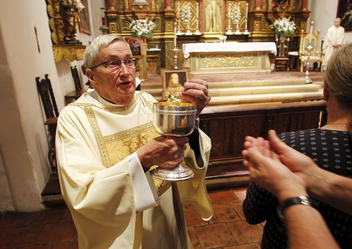 A deacon distributes the Eucharist during Mass at the Carmel Mission Basilica in Carmel, California, on Sept. 23, 2015.