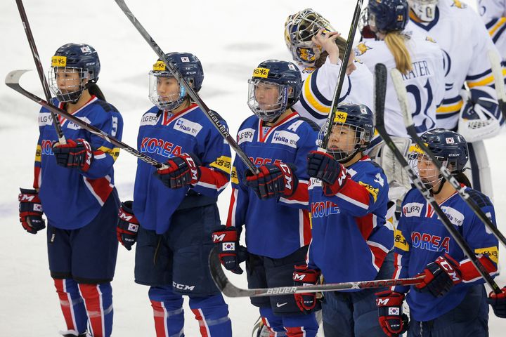 Members of the South Korean women's ice hockey team salute the crowd after an Olympic preparation game against Quinnipiac University in Hamden, Connecticut, U.S.