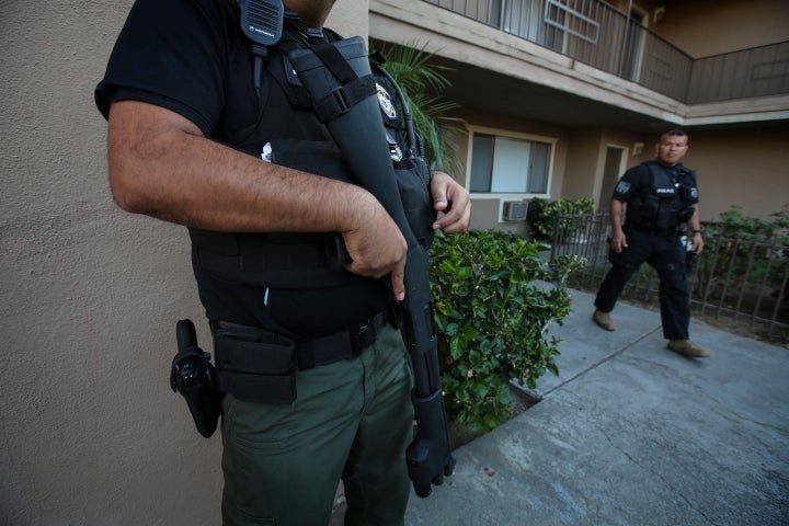 ICE agents carry out a raid to apprehend undocumented immigrants in Riverside, California, last year.