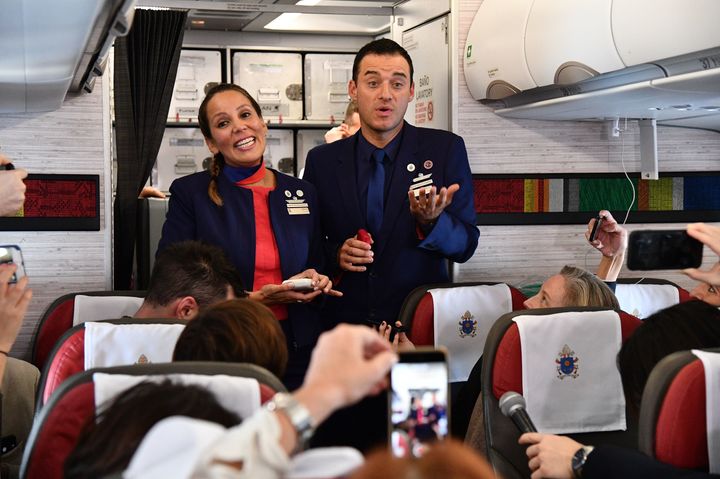 The newly married couple talk to reporters on the plane moments after being married by Pope Francis.