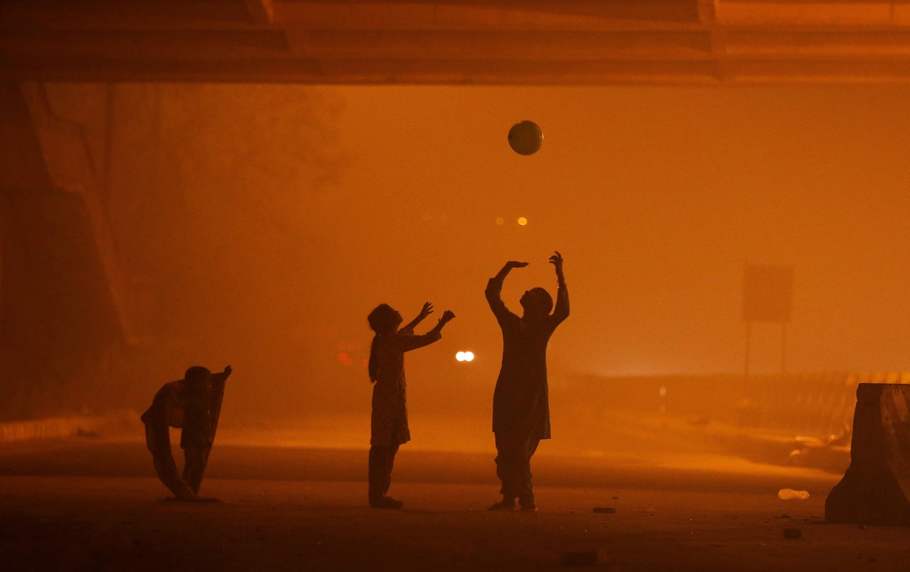 Girls play with a balloon amid heavy smog in New Delhi.
