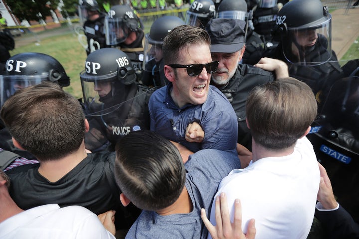 Spencer (in glasses) jammed against a line of riot cops during a white supremacist rally in Charlottesville, Virginia, on Aug. 12, 2017.