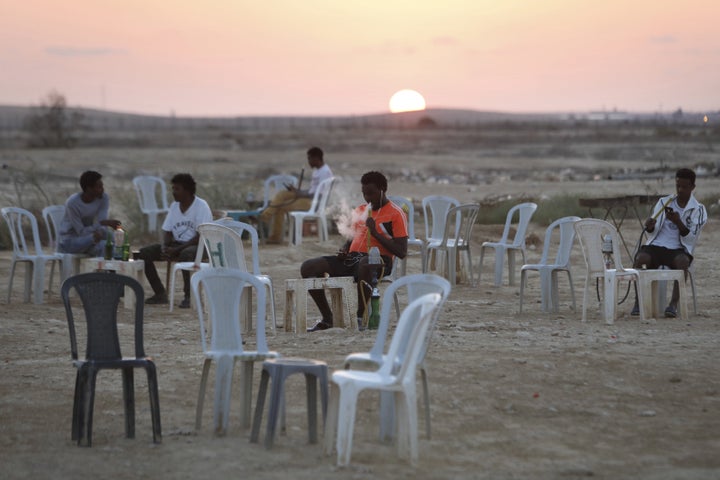 Detained African immigrants spend their free time outdoors in a makeshift cafe outside the Holot detention center, located in Israel's southern Negev desert near the Egyptian border, on Sept. 3, 2017.