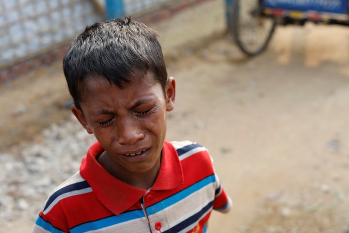 A young Rohingya boys cries outside a hospital in the Kutupalong refugee camp after learning his father was killed, Jan. 13, 2018.