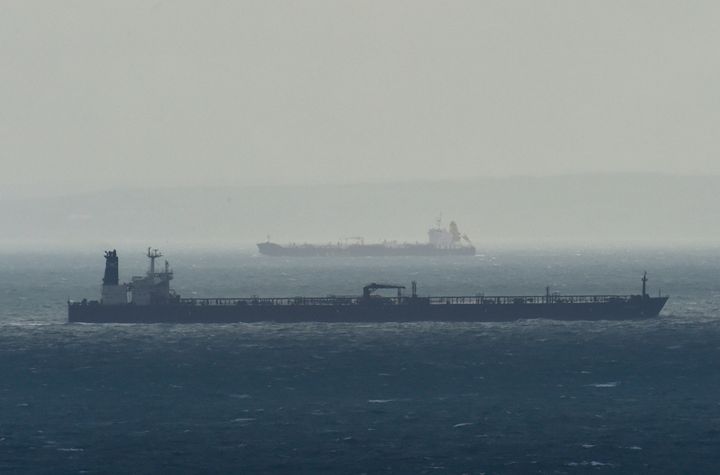 Cargo ships are seen as they sail across the English Channel with the French coast