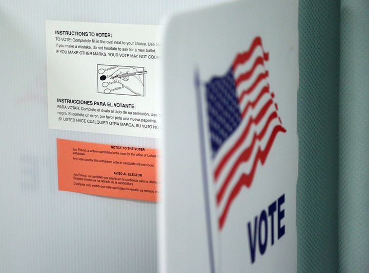 Voting instructions in both English and Spanish are seen on a booth before voters arrived at a polling station in Christmas, Florida, on Nov. 8, 2016.