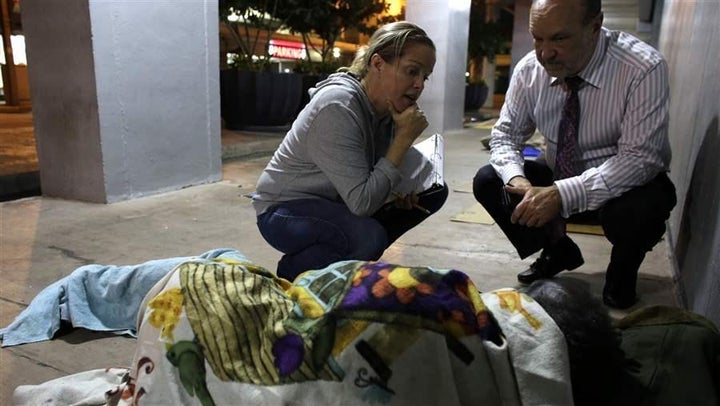 Two volunteers interview a homeless man during the 2017 Point-in-Time count in Miami. This year’s count, for the first time,