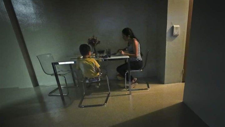 A domestic violence survivor sits with her son for dinner in their new apartment in New York. Among the goals of counting peo