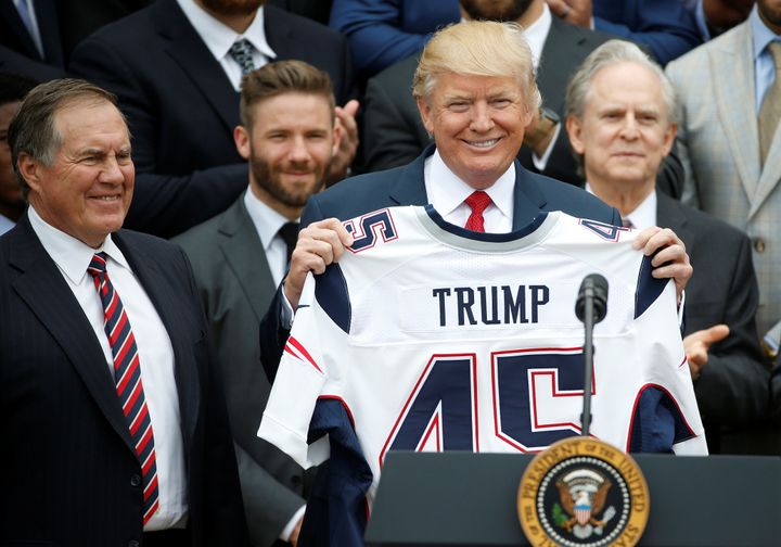 President Donald Trump holds up a New England Patriots jersey during an event at the White House honoring the Super Bowl champions on April 19, 2017. 