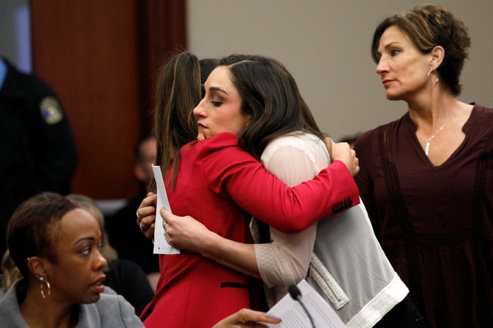 Aly Raisman, left, embraces Jordyn Wieber during the sentencing hearing for Larry Nassar.