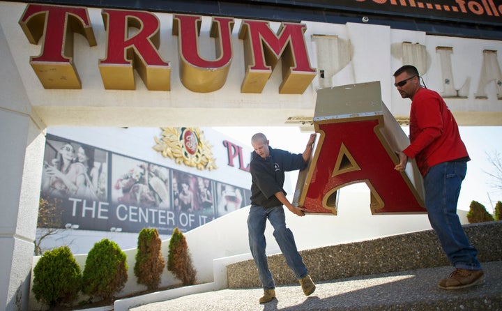 Workers remove the sign from Trump Plaza Casino in Atlantic City, New Jersey, Oct. 6, 2014, after Trump sued to end a licensing deal.