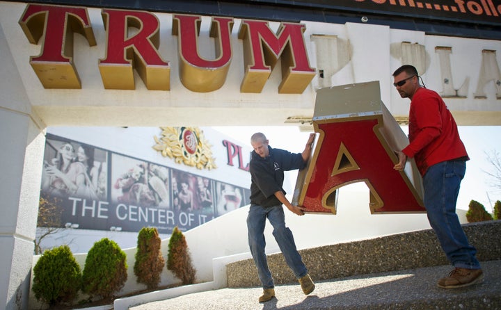 Workers remove the sign from Trump Plaza Casino in Atlantic City, New Jersey, Oct. 6, 2014, after Trump sued to end a licensing deal. 