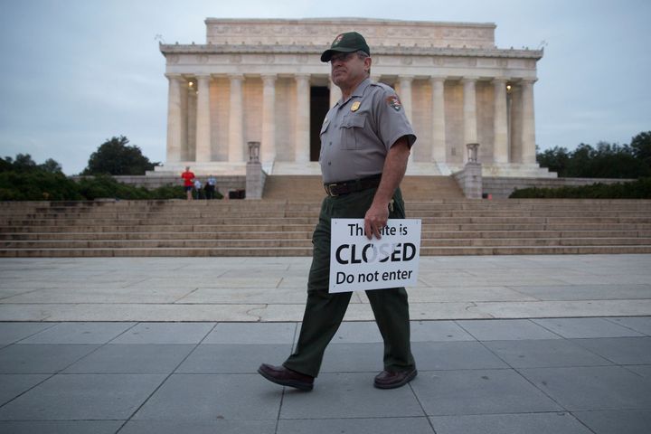 A National Park Service ranger removes a closed sign from the Lincoln Memorial after the 2013 shutdown.