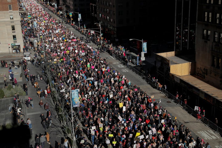 People walk down Sixth Avenue as part of the Women's March in Manhattan on Saturday. 