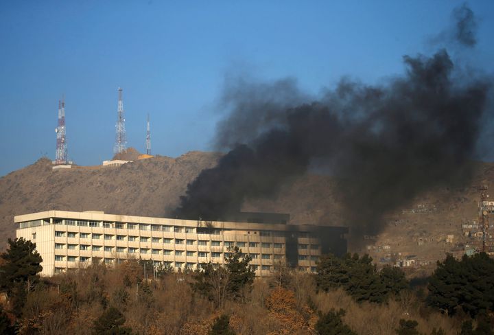 Smoke rises from the top of the hotel where three attackers were shot dead