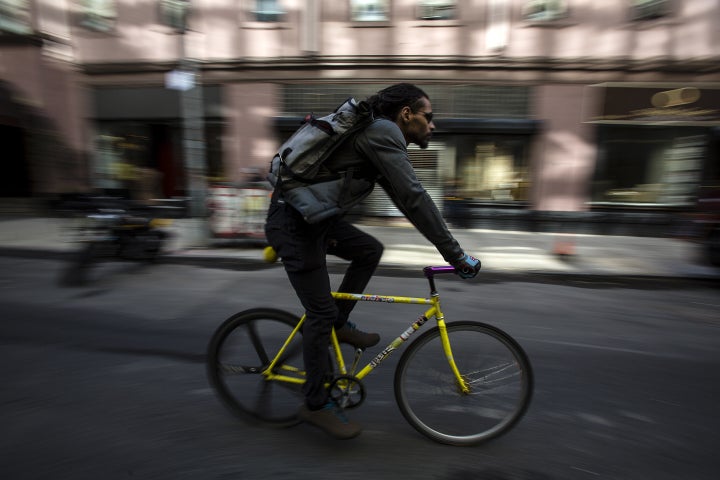 A bike messenger rides through New York. 