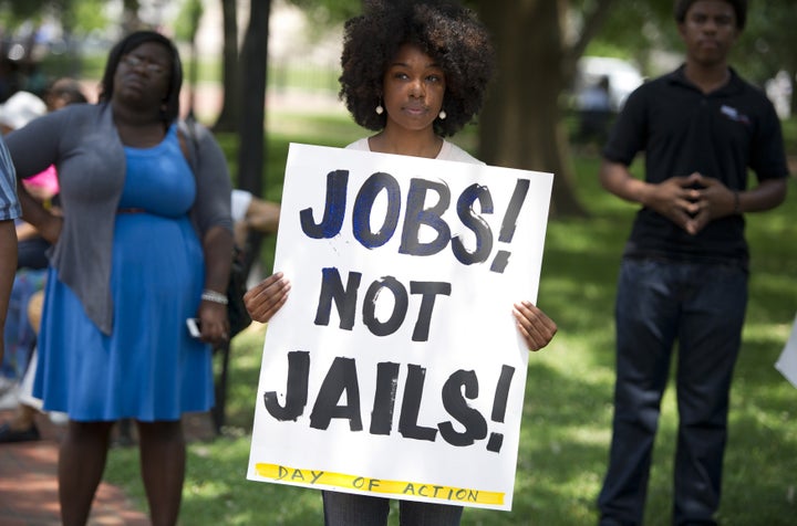 A demonstrator holds a sign during a 2013 rally following a protest march calling on former President Barack Obama to end the so-called War on Drugs.