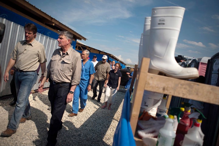 Graham (second from left) is the head of the international relief organization Samaritan's Purse. Here, he visits one of the organization's cholera treatment centers in Port-au-Prince, Haiti, in 2011.