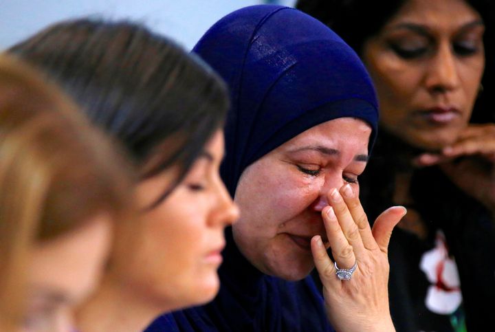 A woman whose relatives are currently being held on the island of Nauru cries at a news conference in Sydney on Oct. 18, 2016.