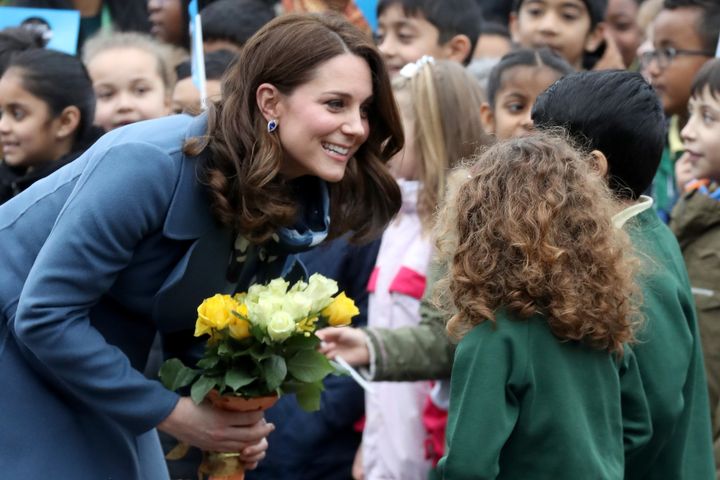 The Duchess of Cambridge talks to children at Roe Green Junior School, London, on 23 January, as she launches the 'Mentally Healthy Schools' website.