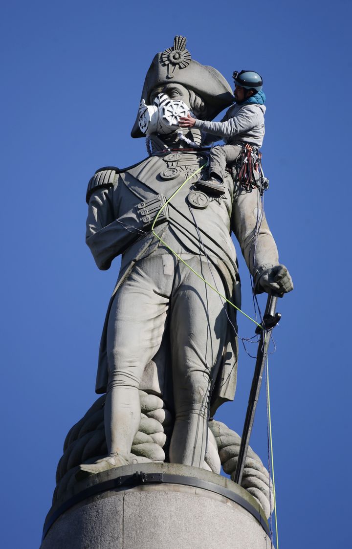 A Greenpeace stunt sees a mask placed on Trafalgar Square's iconic Nelson's Column