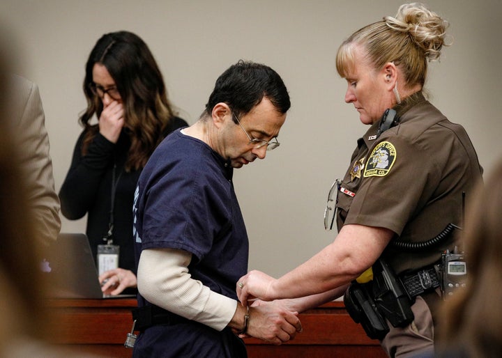 Nassar is handcuffed in the courtroom at the end of a day of testimony during his sentencing hearing.