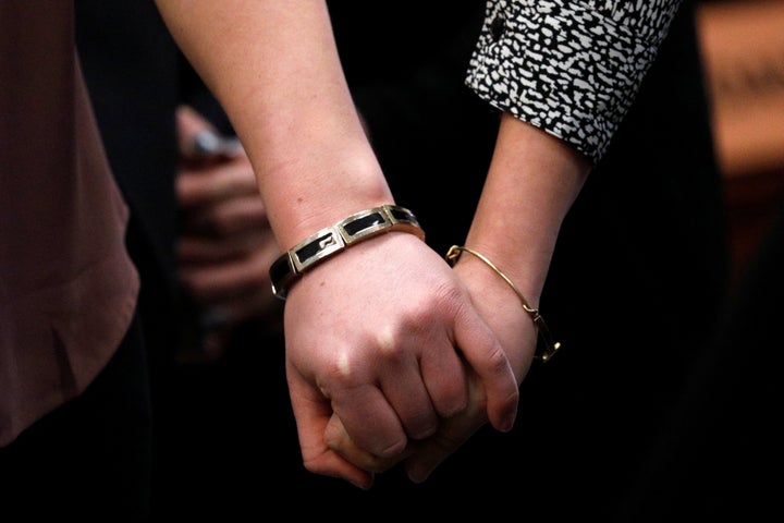 Victims and former gymnasts Maddie and Kara Johnson hold hands as they speak at the sentencing hearing.