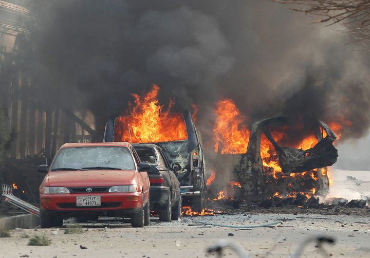 Vehicles are seen on fire after a blast in Jalalabad.