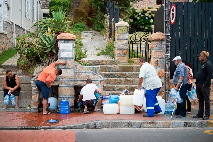 People collect water from pipes in Cape Town on Jan. 19.