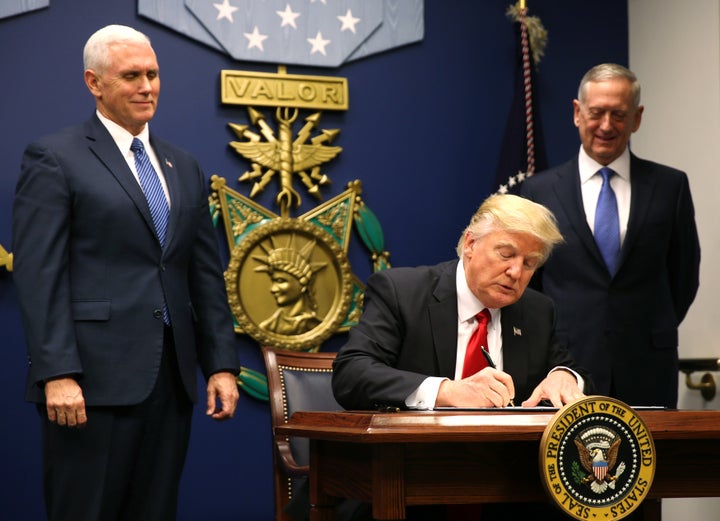 President Donald Trump signs the first ban, Jan. 27, 2017. It barred travel from Muslim-majority countries for 90 days,