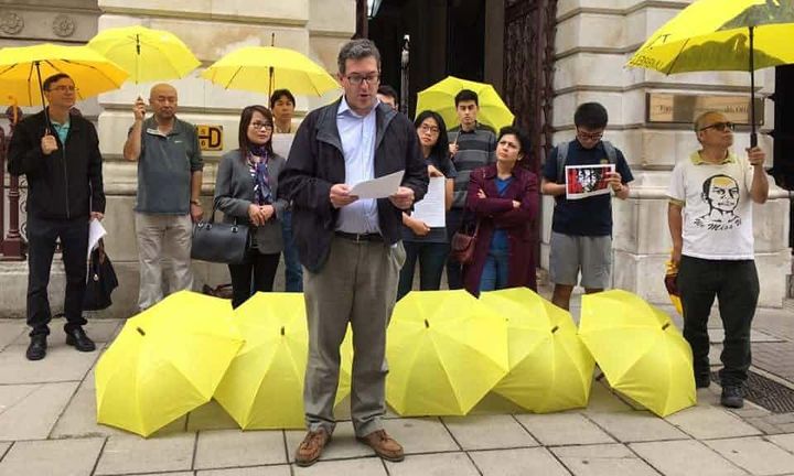 Leading a protest outside the Foreign Office at the imprisonment of activists in Hong Kong