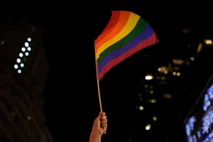 A demonstrator waves a rainbow flag during a dance party in protest of President Donald Trump outside Trump Tower in New York last February.