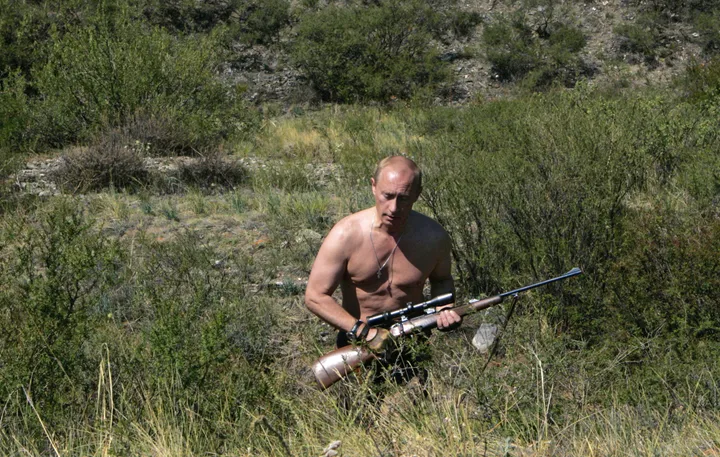 Russian President Vladimir Putin carries a hunting rifle on a trip in August 2007.