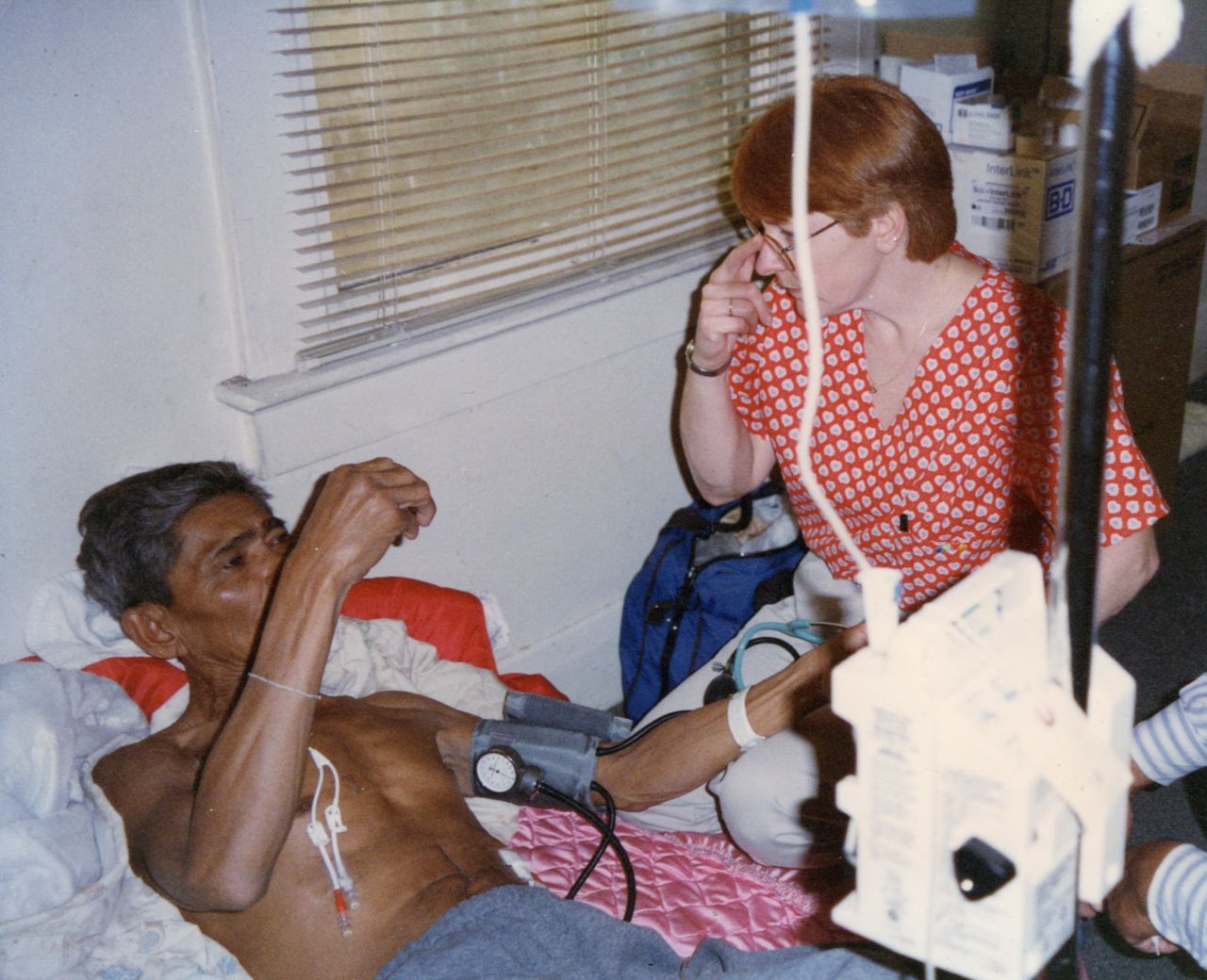 Sok's father is seen with a home nurse in 1997. He died of cancer when Sok was 16.