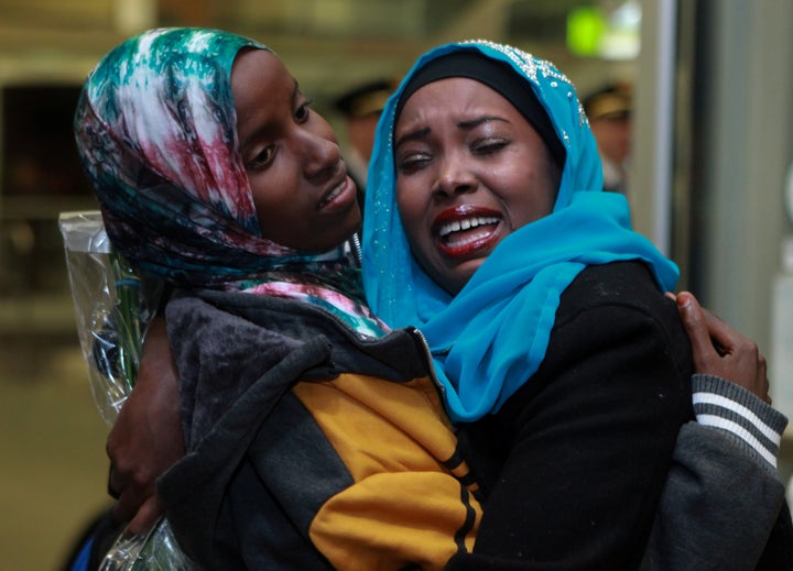 Dahaba Matan (left), a refugee from Somalia, greets her American family members upon arrival at the airport in Bois