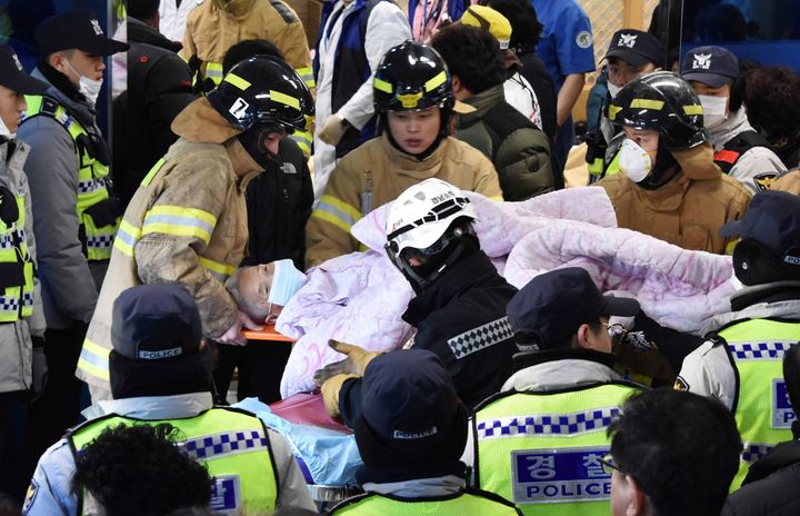 Rescue workers remove a survivor from a hospital in Miryang, South Korea that caught fire. Dozens were killed in the blaze.