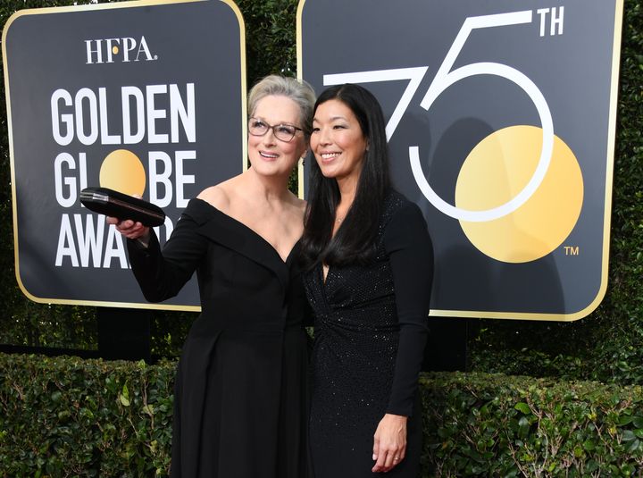 Meryl Streep arriving at the Golden Globes alongside Ai-jen Poo, the head of the National Domestic Workers Alliance
