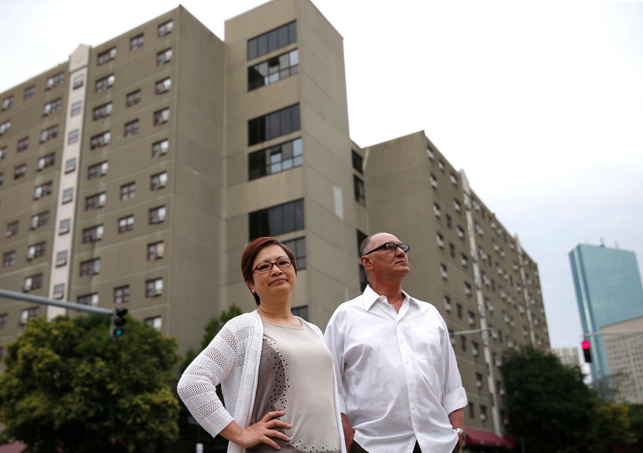 Bill Oranczak and Serene Wong stand in front of Mass Pike Towers.