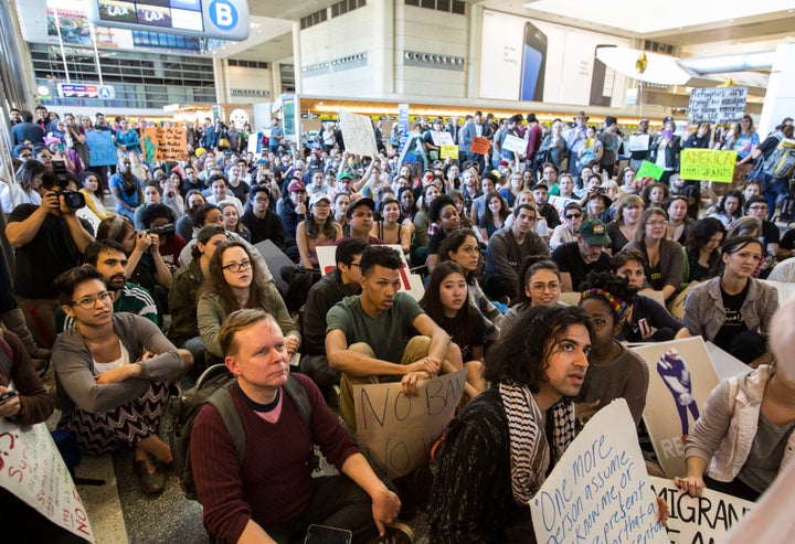 Hundreds sit in on the departure level of the Tom Bradley International Terminal to protest Trump's immigration order at Los Angeles International Airport on Jan. 29, 2017.