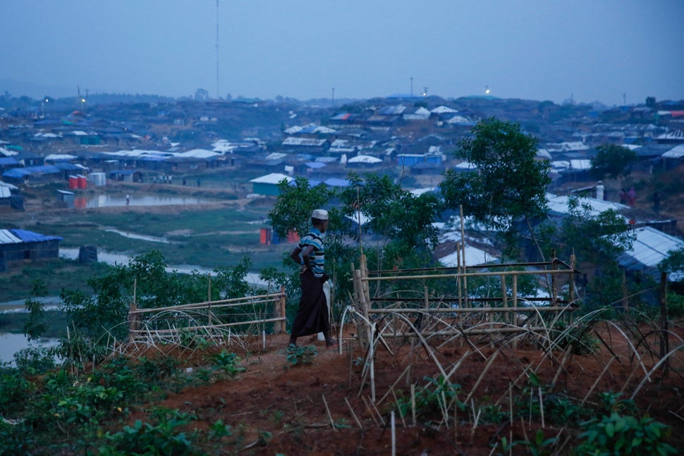 A man walks by fresh graves in Kutupalong, Bangladesh. 