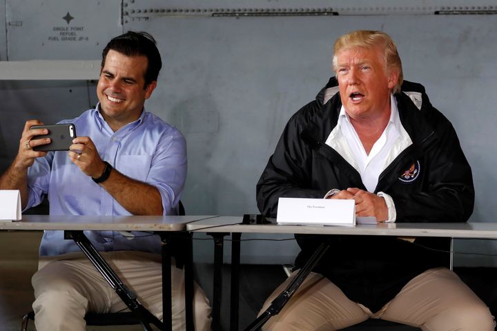 Puerto Rico Gov. Ricardo Rossello, left, takes a picture as he and President Donald Trump receive a briefing on hurricane relief efforts on Oct. 3, 2017.