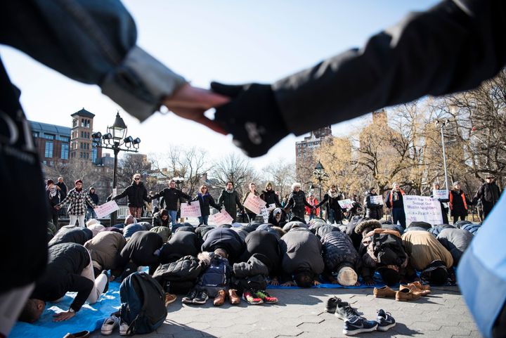 Interfaith allies make a circle around Muslims praying in New York City's Washington Square Park on Jan. 26, 2018. 