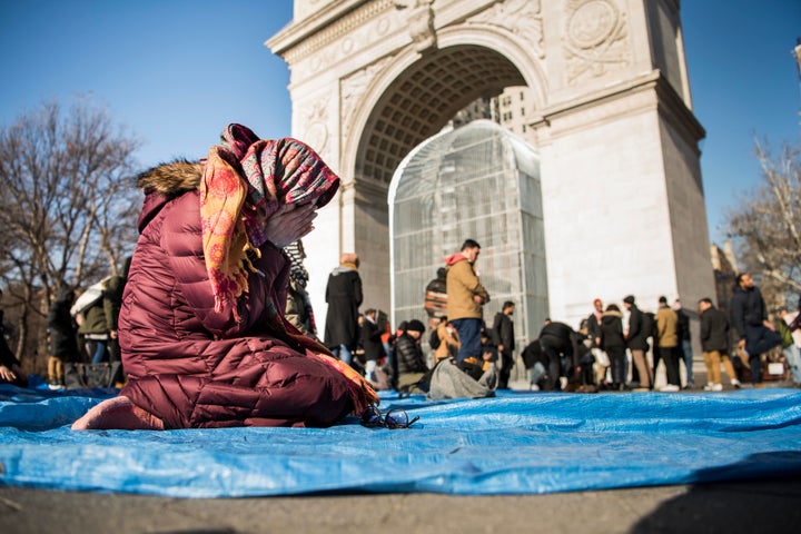 Saima Anjam, senior director of advocacy at the New York Immigration Coalition, prays during a protest event.