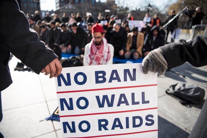 Asad Dandia from the Islamic Center at NYU leads prayers at the rally.